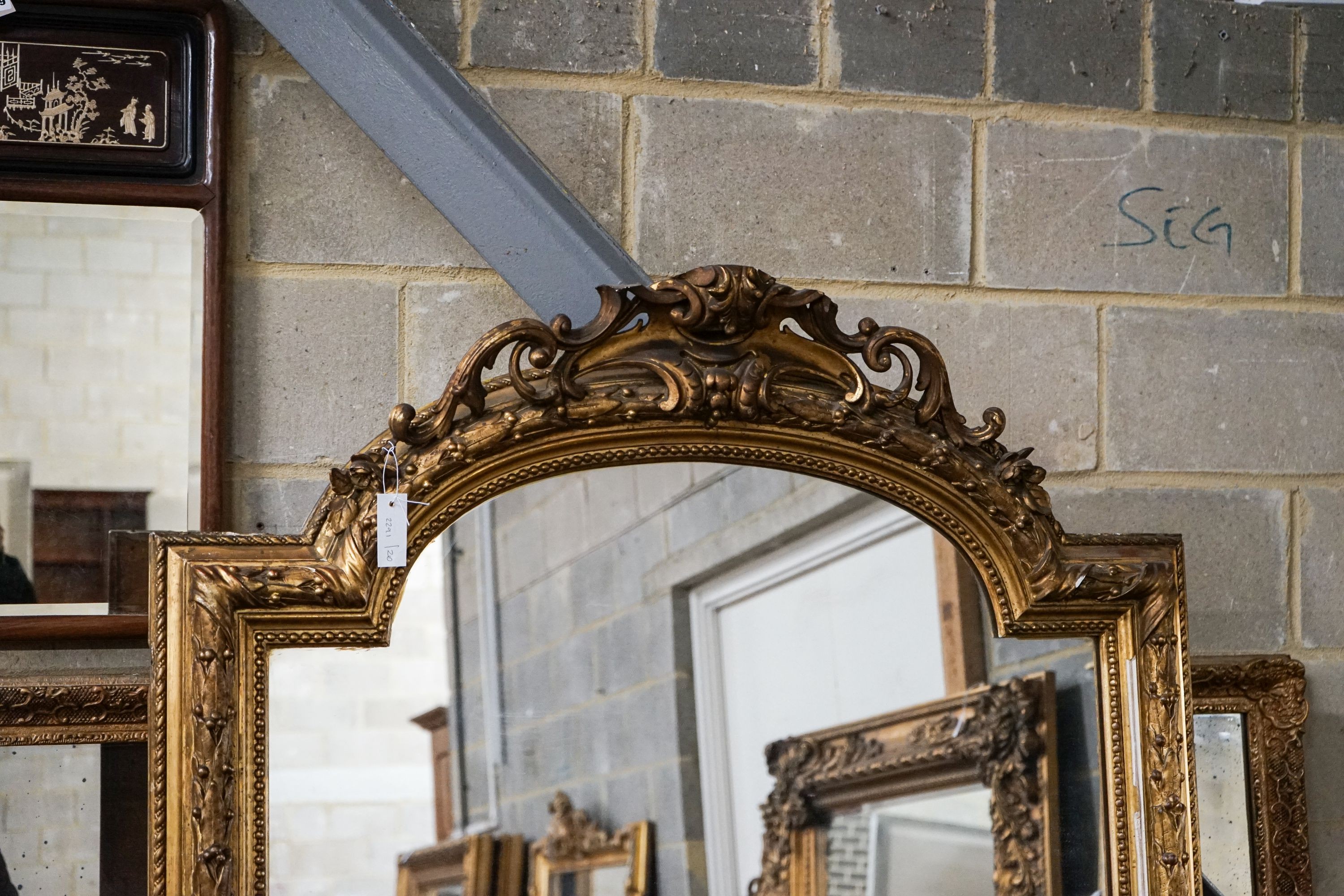 A Victorian giltwood and gesso overmantel mirror with arched scroll pediment, width 112cm, height 180cm